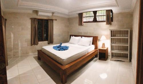 a bedroom with a bed in a room at Darma Yogi House in Ubud