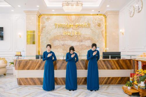 a group of three women standing in front of a stage at Thuận Phát Hotel in Soc Trang