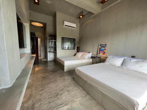 a bedroom with two beds in a room at Vistapaloma beach resort in Odiong