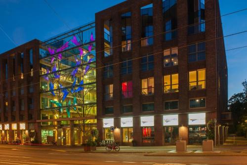 a large brick building with colorful lights on it at Grand Hotel Downtown in Amsterdam
