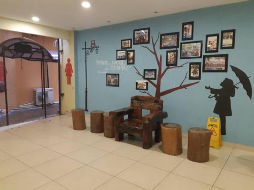 a room with a tree and pictures on the wall at Relax At Gold Coast Morib in Banting