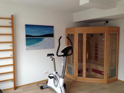 a room with a exercise bike next to a cabinet at i-Motel in Obertshausen
