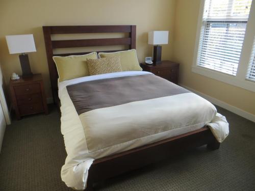 a bedroom with a large bed with two night stands at Walnut Beach Resort in Osoyoos