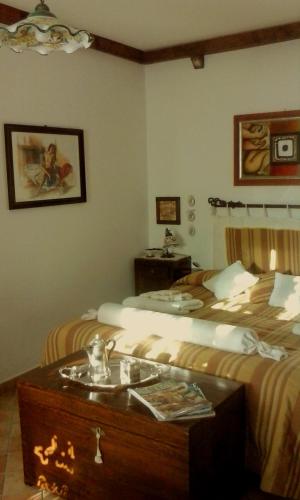 a hotel room with two beds and a table at The Flowers' House in Potenza