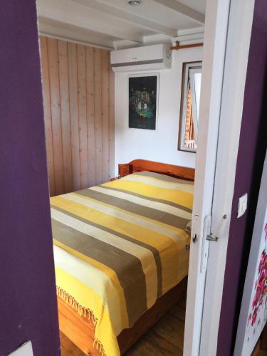 a bedroom with a bed in a small room at SAS L' Ilot Vert in La Saline les Bains