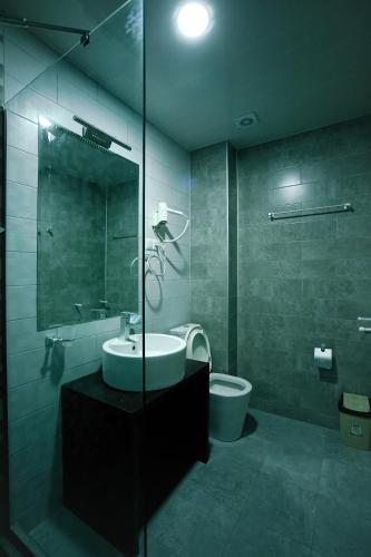a bathroom with a sink and a toilet at Hotel Rero in Kutaisi