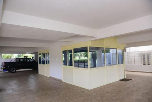 an empty room with a car parked in a building at The Vihar service Apartment in Mysore