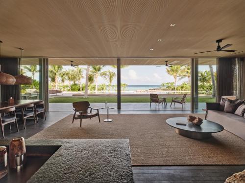 an open living room with a view of the ocean at Patina Maldives, Fari Islands in North Male Atoll