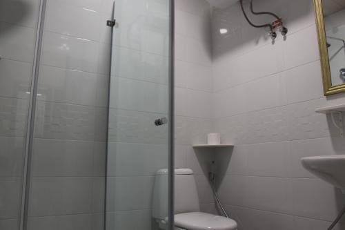 a bathroom with a shower with a toilet and a sink at Boutique Hotel 32 in Batumi
