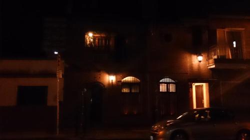 a car parked in front of a building at night at Hospedaje San Lorenzo in Corrientes