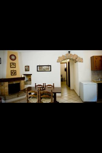 a living room with a table and a kitchen at Bed And Breakfast Mblò in Fondi