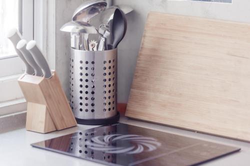 a container of utensils on a counter next to a window at DoGoo in Kaohsiung