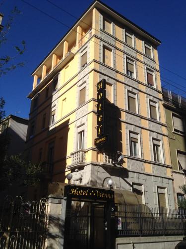 a building with a sign on the side of it at Hotel Vienna in Milan