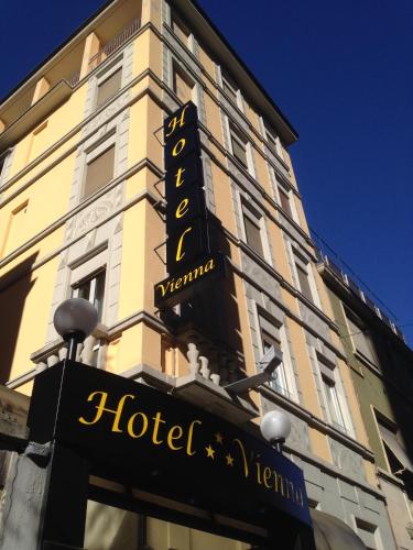 a hotel sign on the side of a building at Hotel Vienna in Milan