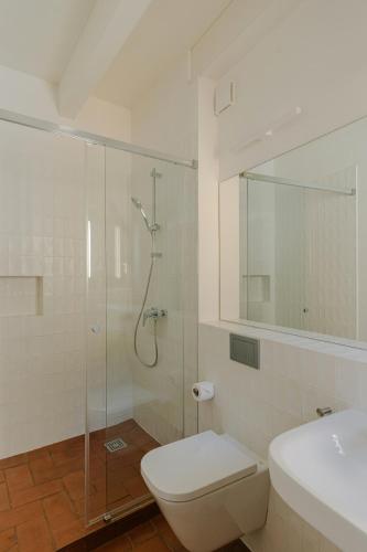 a bathroom with a shower and a toilet and a sink at Flateli Santa Clara 21 in Girona
