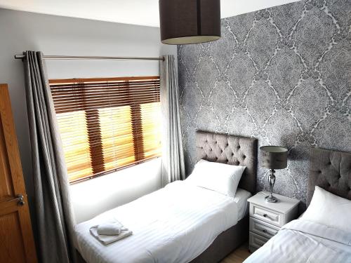 Ένα ή περισσότερα κρεβάτια σε δωμάτιο στο Foxhollow House Suite