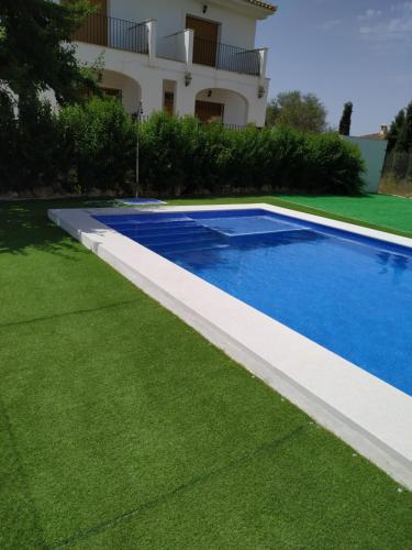 a swimming pool in the yard of a house at Apartamentos el Volapie in Montemayor