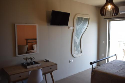 a bedroom with a desk and a mirror and a bed at Αιγιαλίς - Πολυτελη διαμερισματα in Karistos