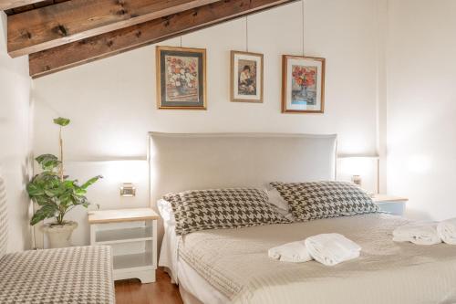 a bedroom with a bed with two towels on it at Hotel Villa Sara in Mestre