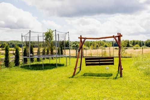 a park with a bench and a swing at ŚwiętySpokój Puszcza in Białowieża