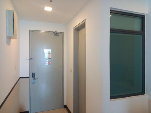a hallway with a glass door and a window at Sunset View 969 PD Waterfront in Port Dickson