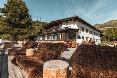 a group of hay bales in front of a building at Alpenblick Bergrestaurant & Hotel in Arosa