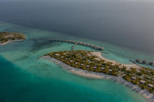 an aerial view of an island in the ocean at Patina Maldives, Fari Islands in North Male Atoll