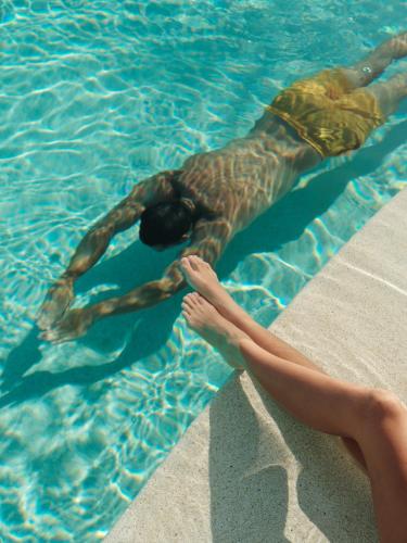 a man laying in a swimming pool at Patina Maldives, Fari Islands in North Male Atoll