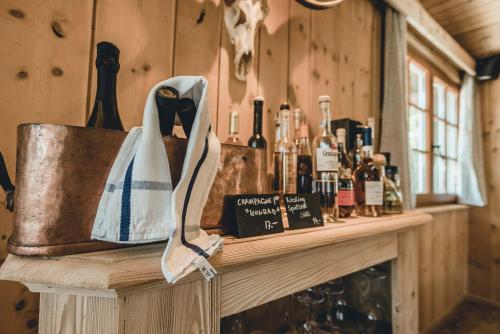 a counter with bottles of wine and a bag on it at Alpenblick Bergrestaurant & Hotel in Arosa