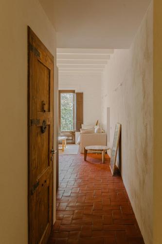 a hallway with an open door and a living room at Flateli Santa Clara 12 in Girona