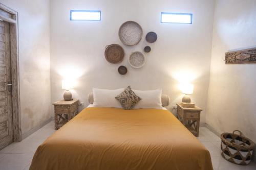 a bedroom with a large bed with two night stands at Gypsy Moon Bali in Canggu