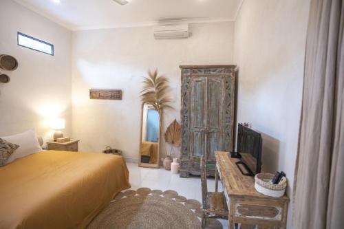 a bedroom with a bed and a large mirror at Gypsy Moon Bali in Canggu