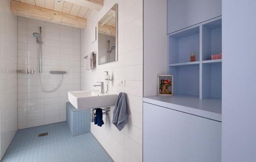 a white bathroom with a sink and a shower at Refugium 1744 in Oberscheinfeld
