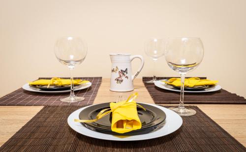 a table with plates and glasses of wine at Stylish 2BD Apartment with a Nice Cozy Terrace by Flat Mаnager in Plovdiv
