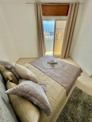 a bedroom with a couch and a large window at Superbe Appartement Avec Cheminée in Tangier