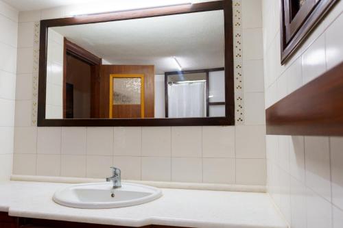 a bathroom with a sink and a mirror at EMPHASIS Traditional House 