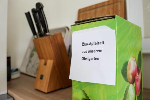 a green bag sitting on a counter next to a knife block at Moderne Ferienwohnung Nähe Bad Griesbach, Haarbach in Haarbach