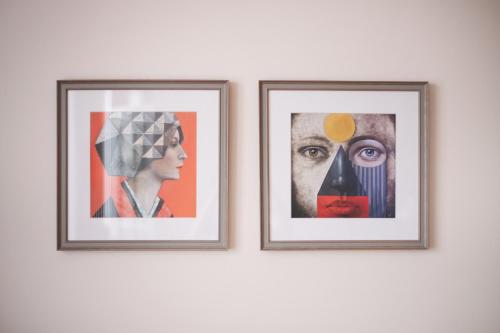 two framed pictures of a woman on a wall at Art & Comfort Home in Kaunas