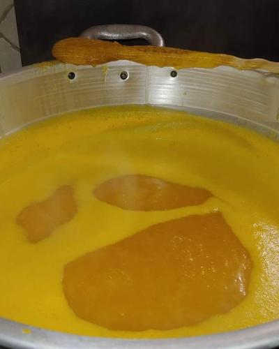 a pot full of yellow sauce in a bowl at AFFITTACAMERE DORGALI B&B da ZIETTO in Dorgali
