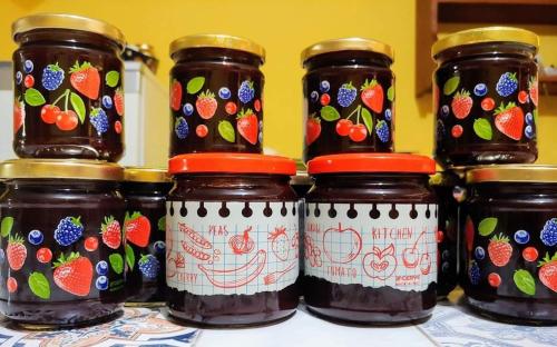 a group of jars of jam on a table at AFFITTACAMERE DORGALI B&B da ZIETTO in Dorgali