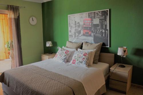 a bedroom with a large bed with green walls at Casa Lagarto in El Paso