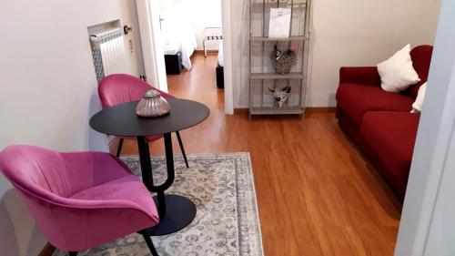 a living room with a table and two chairs and a couch at Il Roseto in Frosinone