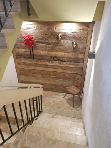 a staircase with a wooden wall with a flower on it at Pension Florianhof in Schonach
