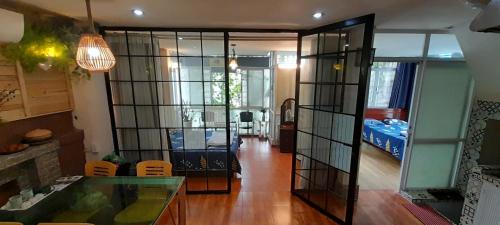 a room with a glass door leading to a bedroom at Green Homestay in Hanoi