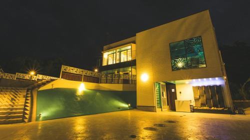 a building with a pool in front of it at night at The Resort Villa Kochibanta Okinawa in Kudeken