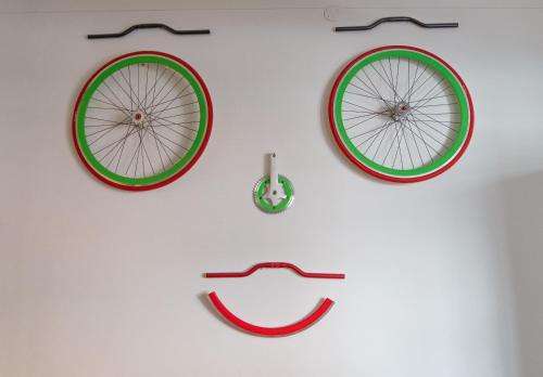 a wall with three different types of bicycle clocks at Bed & Bike Ferrara in Ferrara