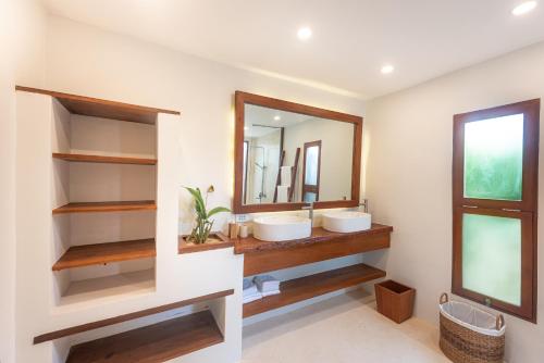 a bathroom with two sinks and a mirror at Rare Beachfront Villa - 2BR - 6 Pax Private Pool on Tuason Surf Spot in General Luna