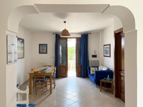 a living room with a table and a blue couch at Antonella B&B in Leuca