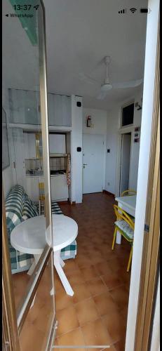 a living room with a table and a mirror at San Salvo Marina Bilocale in Marina di Montenero