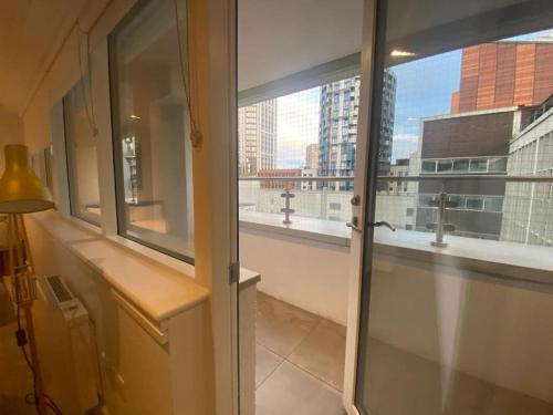 a room with a window with a view of a city at 90s RETRO 1Bed Studio Apartment Wembley Park London Private GYM & CINEMA & Netflix Perfect for Solo & Coupled Travellers in London